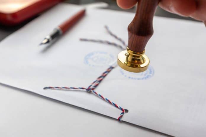 Notary public wax stamper. White envelope with brown wax seal, golden stamp. Responsive design
